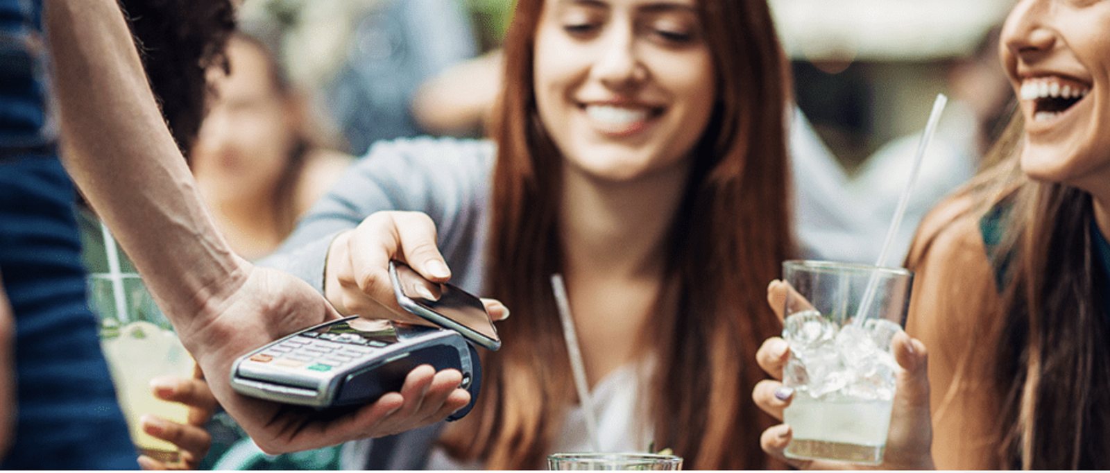 Fans paying with their phone while out together