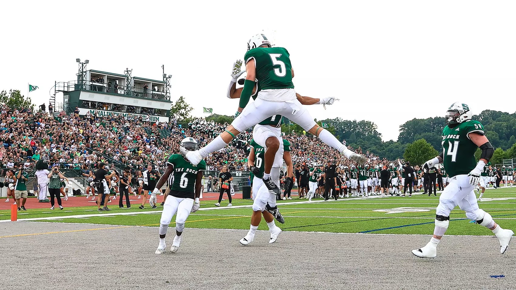 A Slippery Rock football player leaping into the endzone